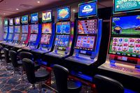 Vibrant casino slot machines lit up at night