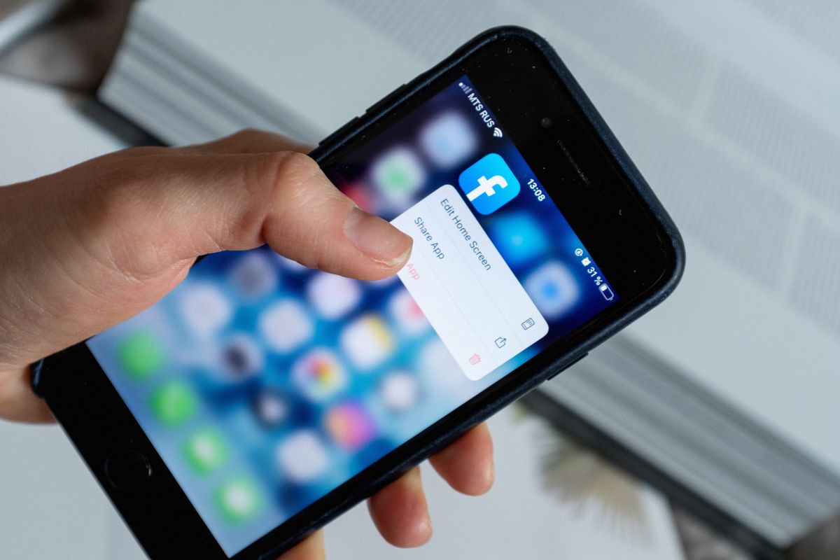 A person choosing an option from a pop-up window while opening an app on a smartphone