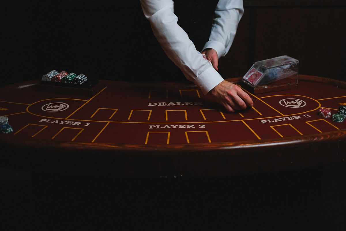 A croupier dealing cards at a casino table