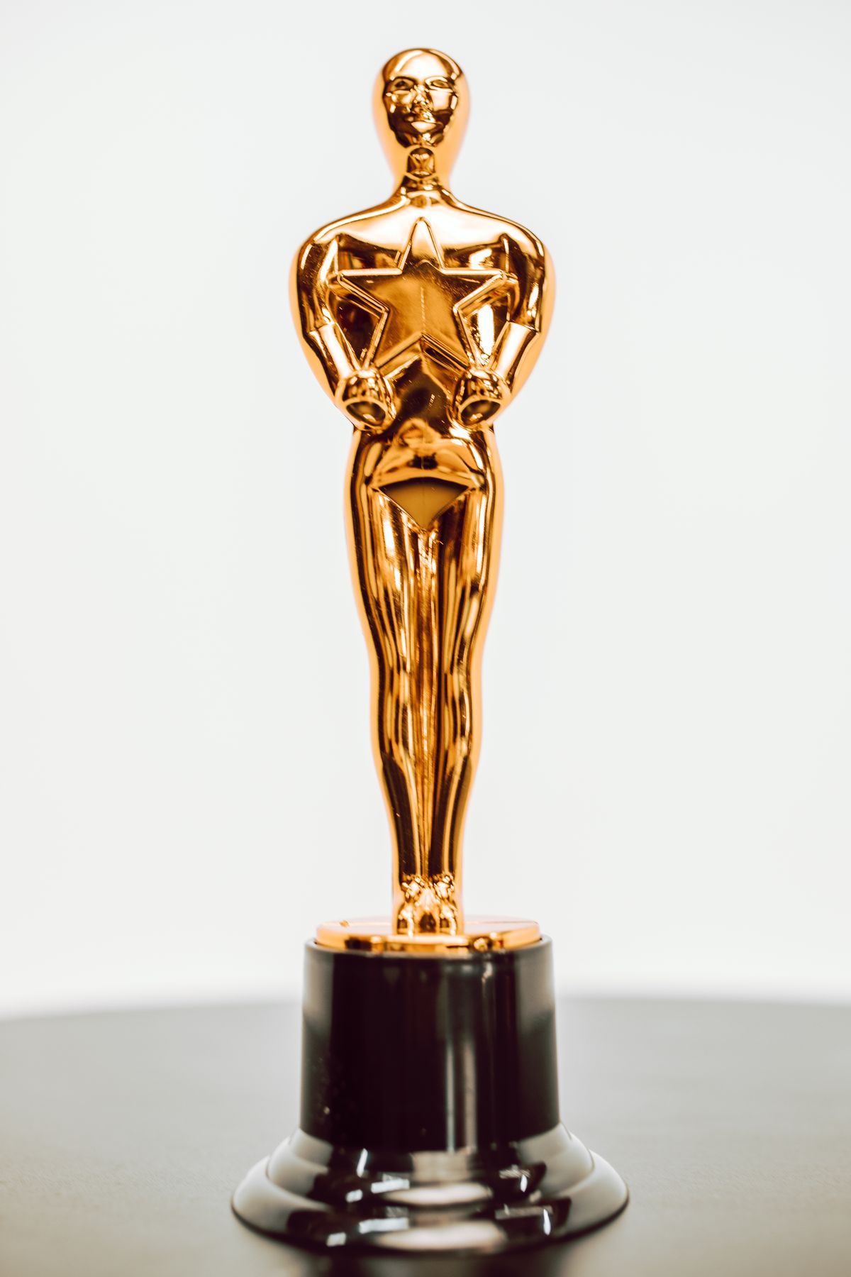 A gold star trophy on a dark base