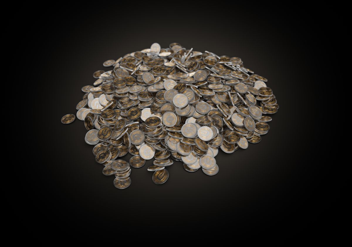 A large pile of assorted coins on a dark background