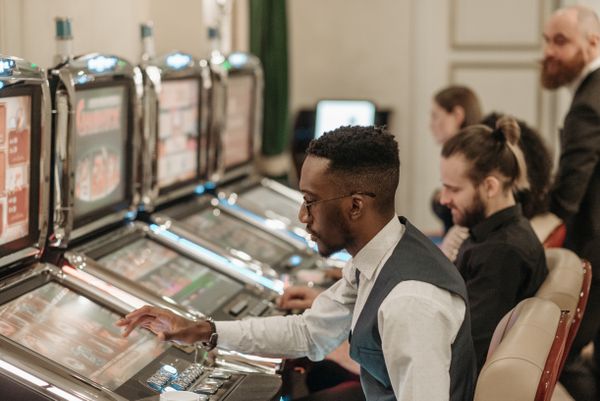 Players spinning slot machines in a casino