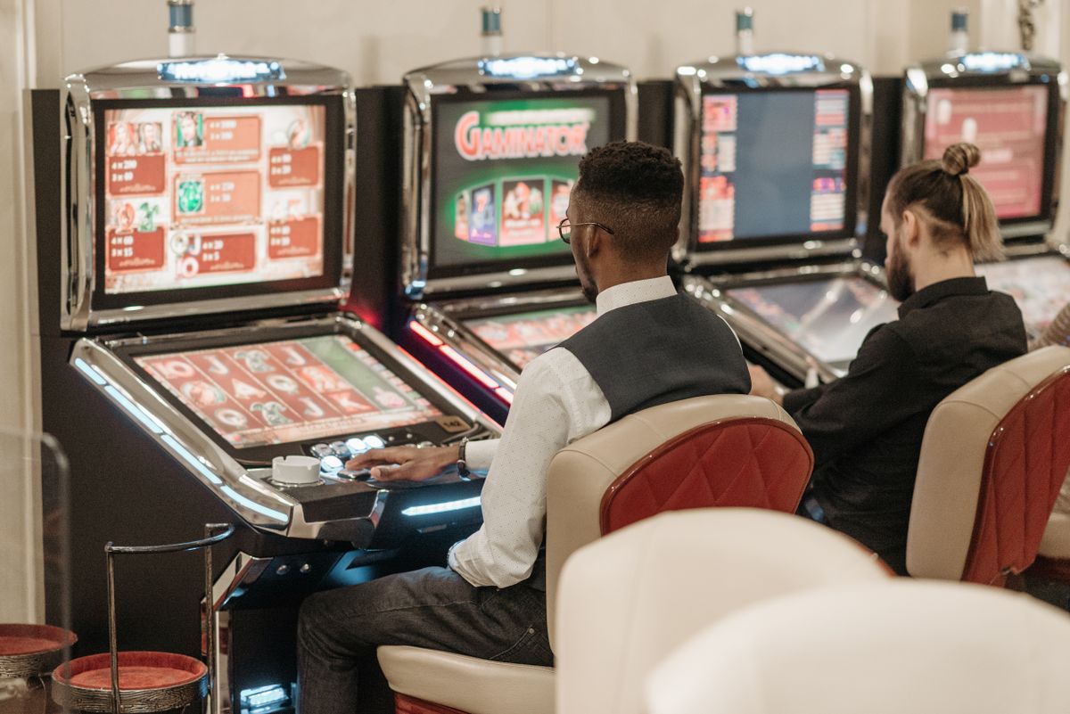 Players trying their luck on slot machines in a casino