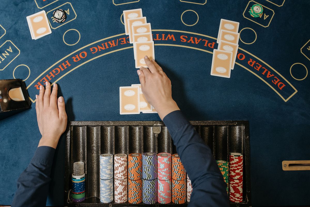 Dealer's hands distributing cards at a blackjack table