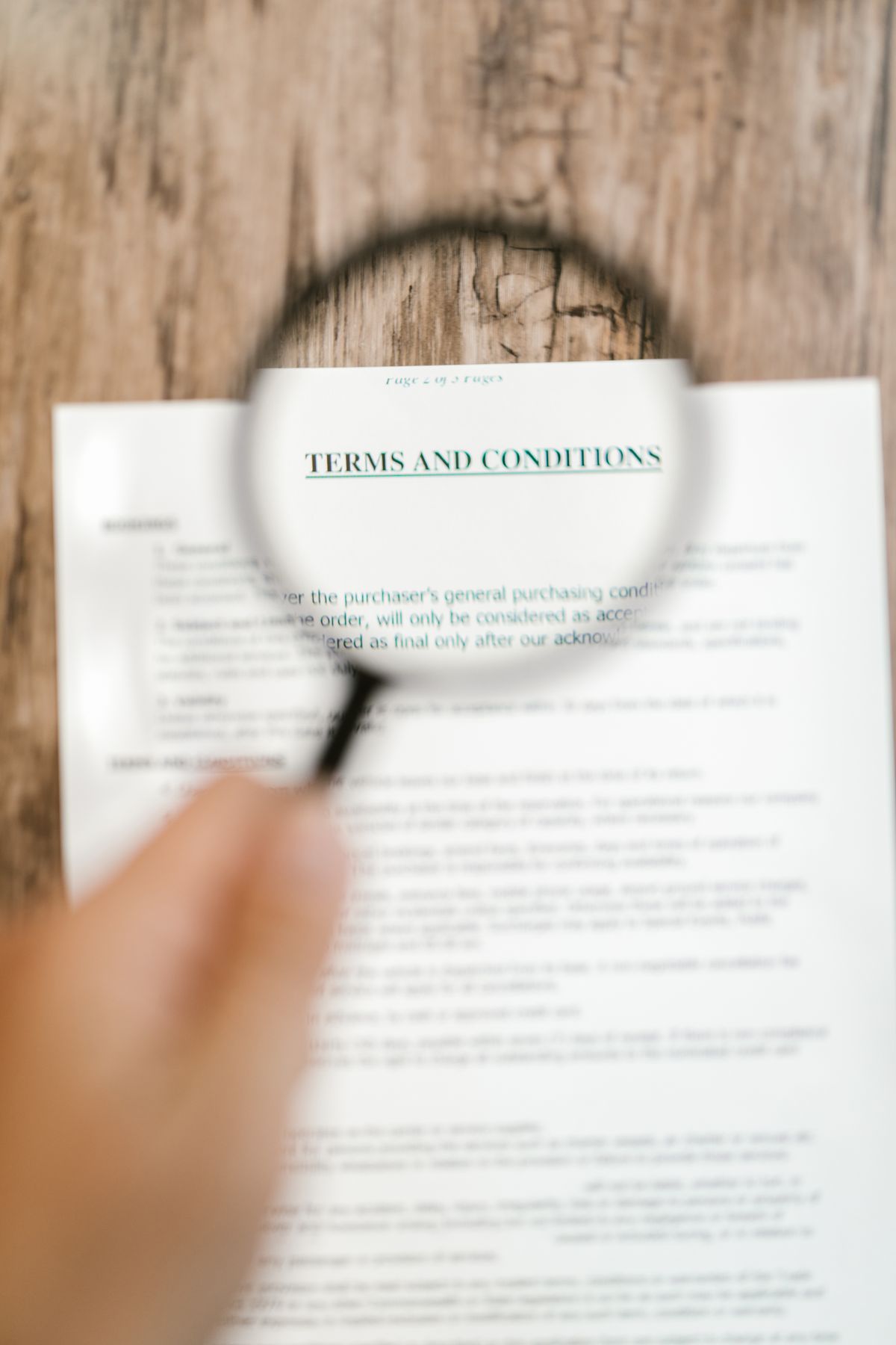 Magnifying glass focused on the terms and conditions of a document